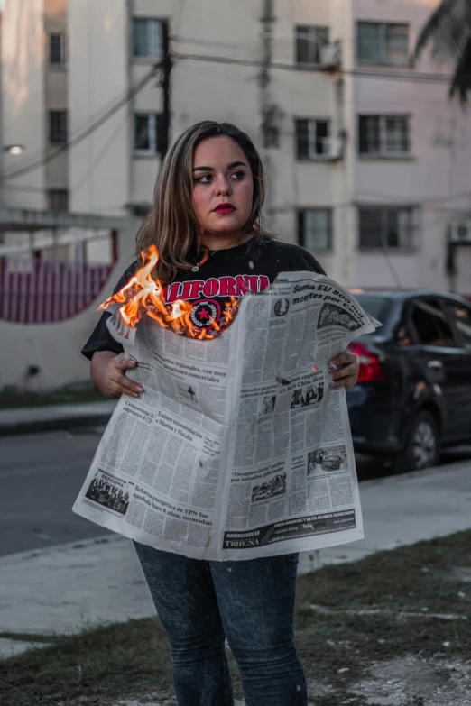 a woman standing next to a fire hydrant holding a newspaper, a cartoon, by Alejandro Obregón, pexels contest winner, fireball lighting her face, streetwear, latino features, gif