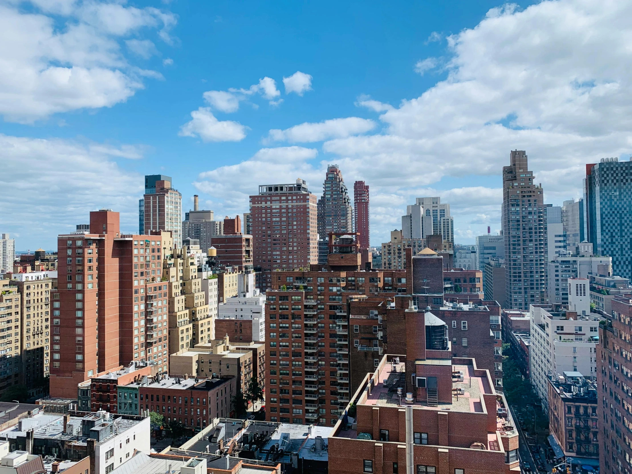 a view of a city from a high rise building, unsplash contest winner, american barbizon school, clear blue skies, rundown new york apartment, many buildings, slide show