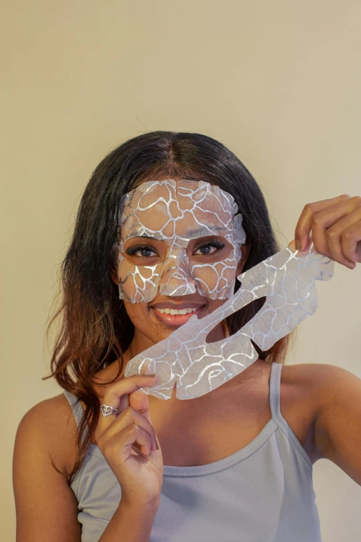 a woman holding a knife in front of her face, see through glass hologram mask, flawless epidermis, detailed product image, white metallic