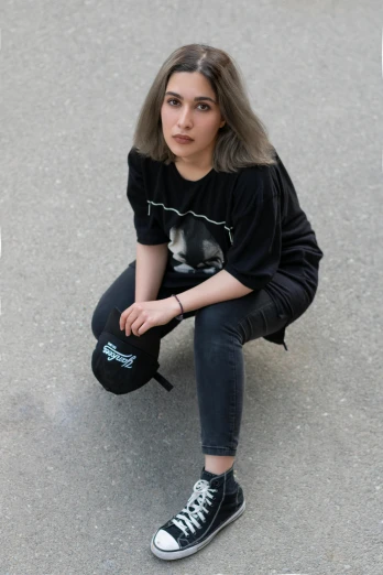 a woman sitting on a skateboard in a parking lot, an album cover, inspired by Hannah Frank, black t - shirt, headshot photo, trending on r/streetwear, black cap