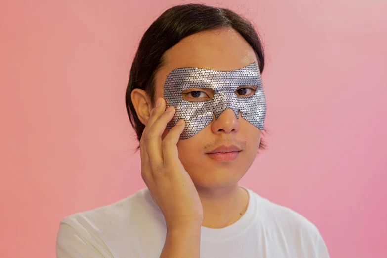 a close up of a person with a mask on, set on singaporean aesthetic, chrome silver, grid of eye shapes, product shot