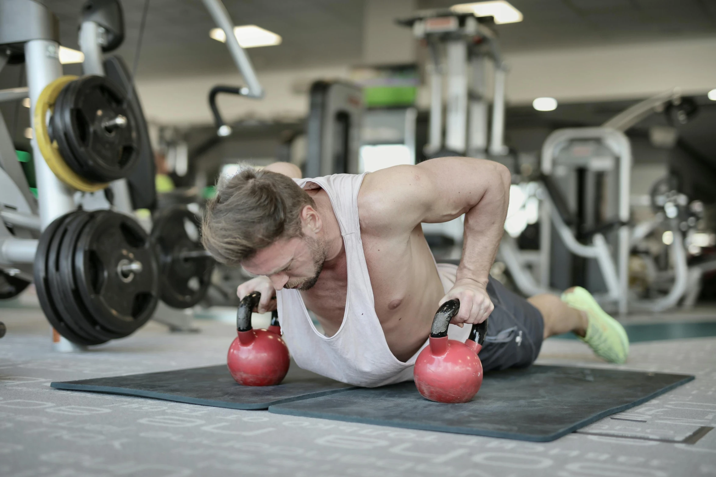 a man doing push ups with kettlebells in a gym, by Tom Bonson, pexels contest winner, lachlan bailey, 6 pack ab, thumbnail, caucasian