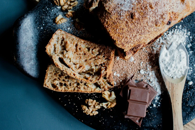 a plate topped with slices of bread covered in powdered sugar, a portrait, unsplash, walnuts, chocolate. rugged, cosy, thumbnail