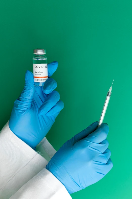 a person in a lab coat holding a syet, shutterstock, renaissance, cyan and green, syringe, gloves on hands, instagram picture