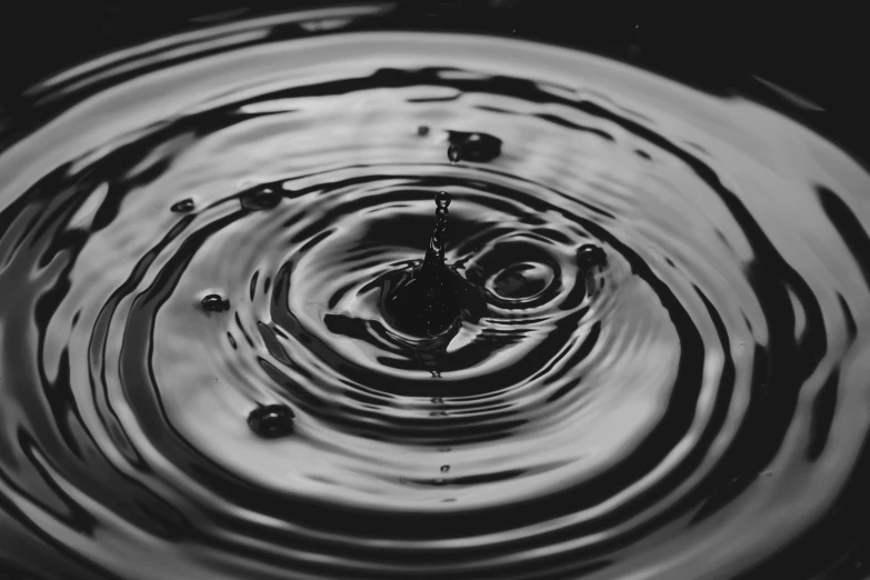 a black and white photo of a drop of water, by Niko Henrichon, pexels, dmt ripples, unsplash 4k, accurate and detailed, honey ripples