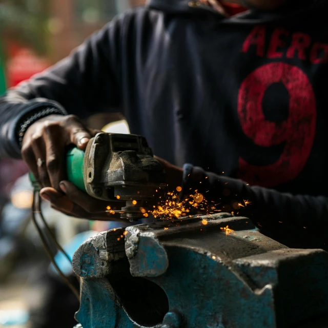a close up of a person using a machine, by Frederik Vermehren, pexels contest winner, arbeitsrat für kunst, nepal, cast iron material, brandon woelfel, chopping hands