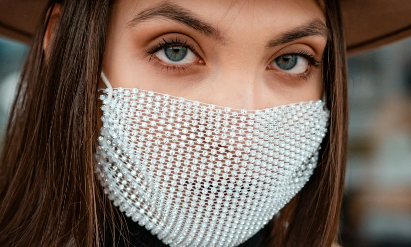 a close up of a person wearing a face mask, a stipple, trending on pexels, plasticien, made of crystal, silver, girl with white eyes, fashionable