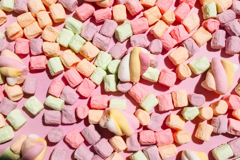 a pile of marshmallows sitting on top of a pink surface, inspired by Peter Alexander Hay, trending on pexels, fruit, multicoloured, high angle close up shot, tummy