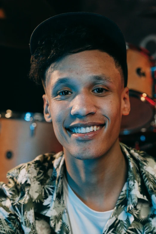 a man sitting in front of a drum kit, by Jacob Toorenvliet, detailed smile, ashteroth, headshot photo, shaven face