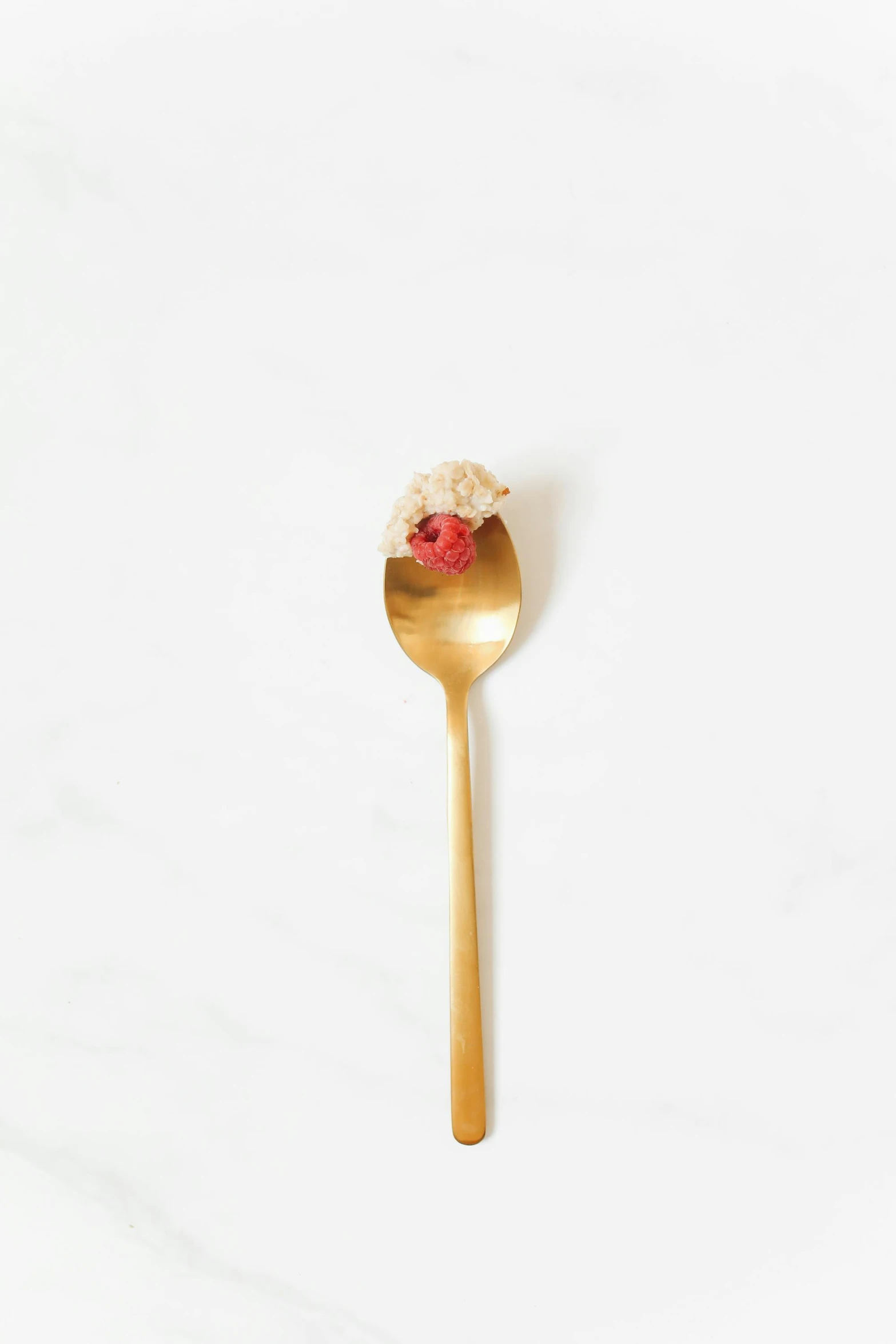 a gold spoon with a raspberry on it, unsplash, minimalism, strawberry embellishment, very crispy, natural point rose', models