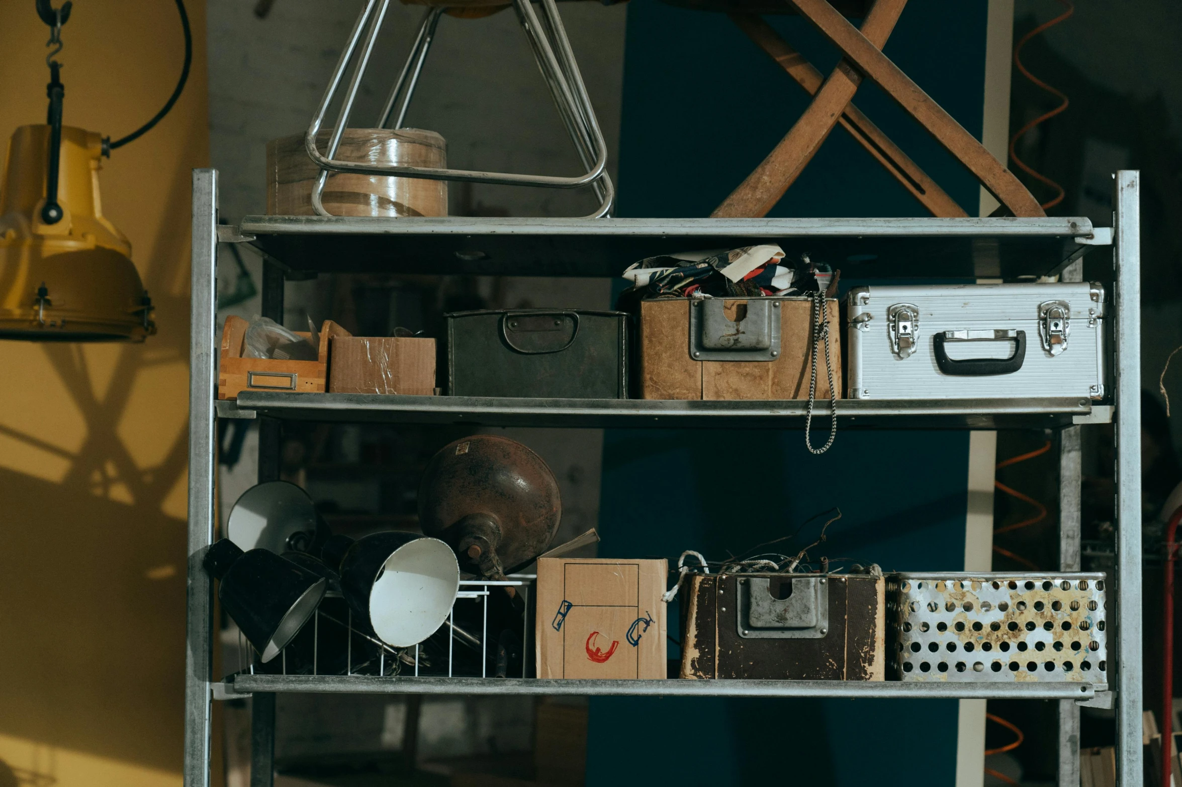 a metal shelf filled with lots of assorted items, unsplash, assemblage, brown, luggage, cinematatic lighting, units