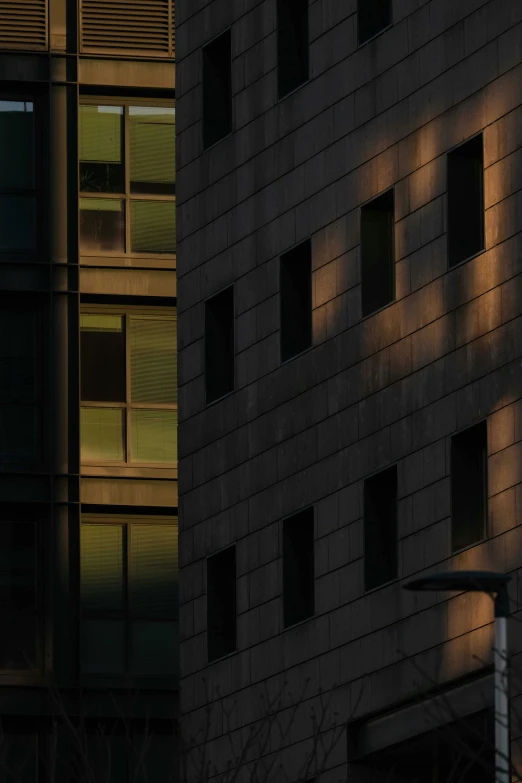 a couple of tall buildings sitting next to each other, a picture, unsplash contest winner, light and space, face in the shadows, telephoto shot, taken in the late 2010s, square shapes