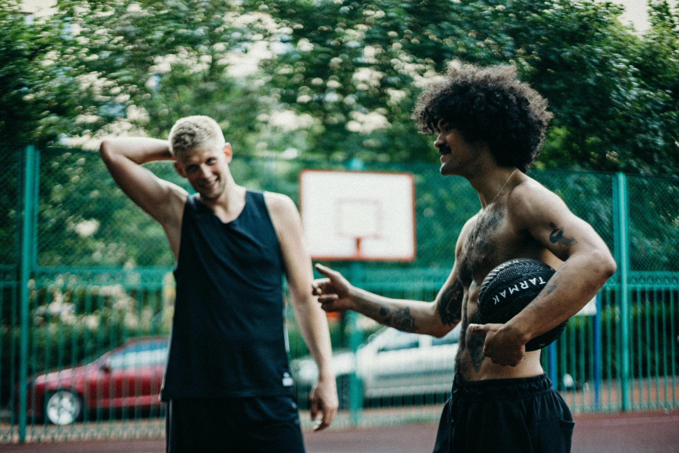 a couple of men standing on top of a basketball court, pexels contest winner, no tattoos, both laughing, maxim shirkov, a blond