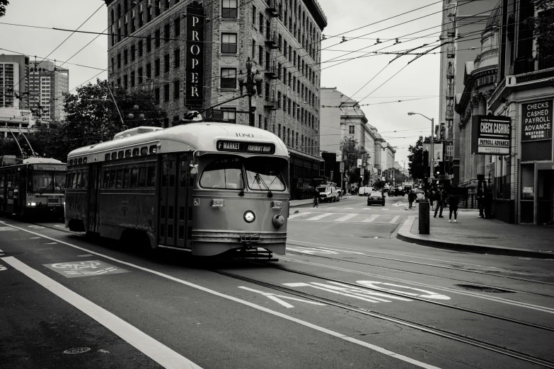 a black and white photo of a city street, inspired by Vivian Maier, unsplash contest winner, street tram, bay area, sepia toned, square