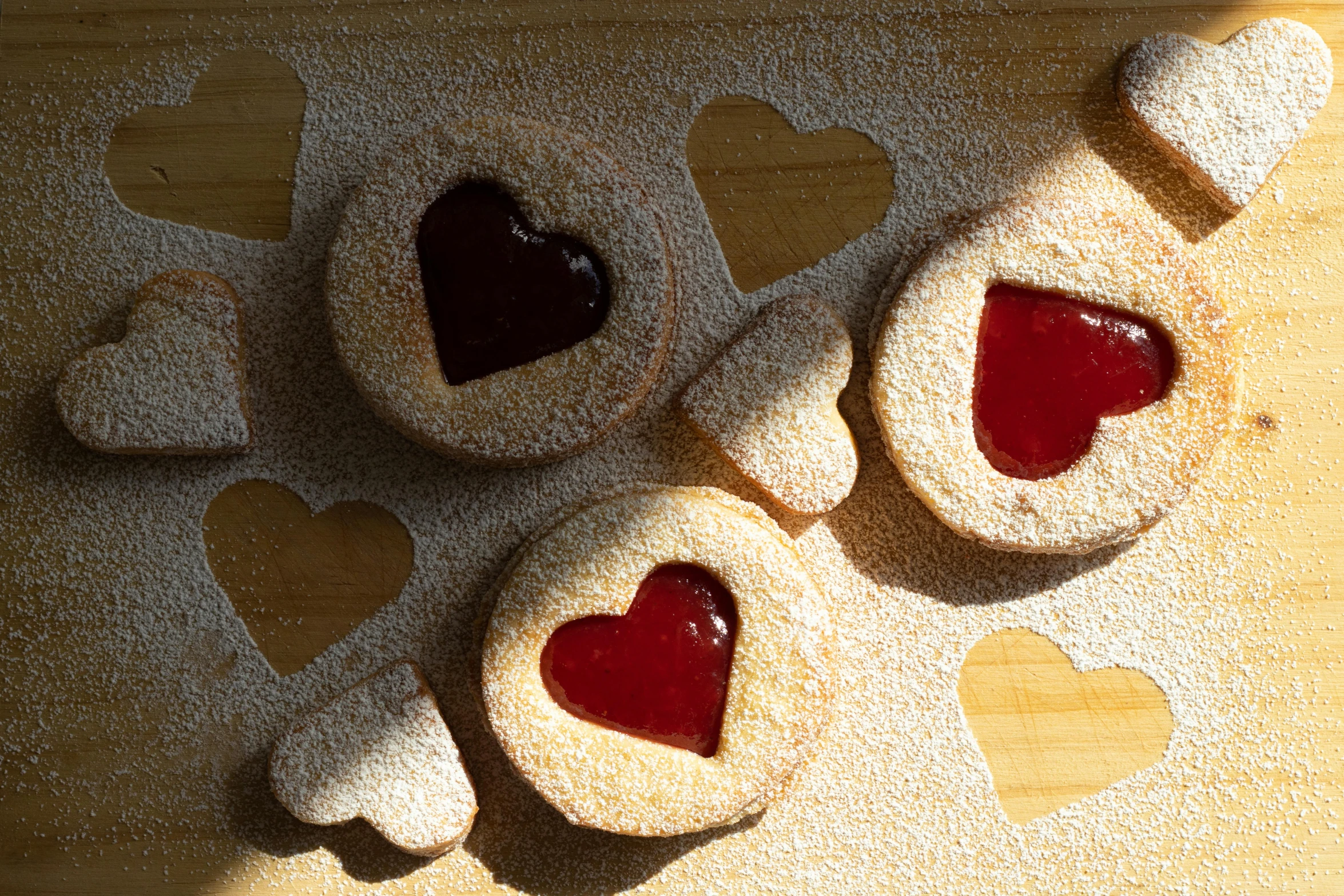 a couple of heart shaped cookies sitting on top of a cutting board, pexels, instagram post, thumbnail, halos, various sizes