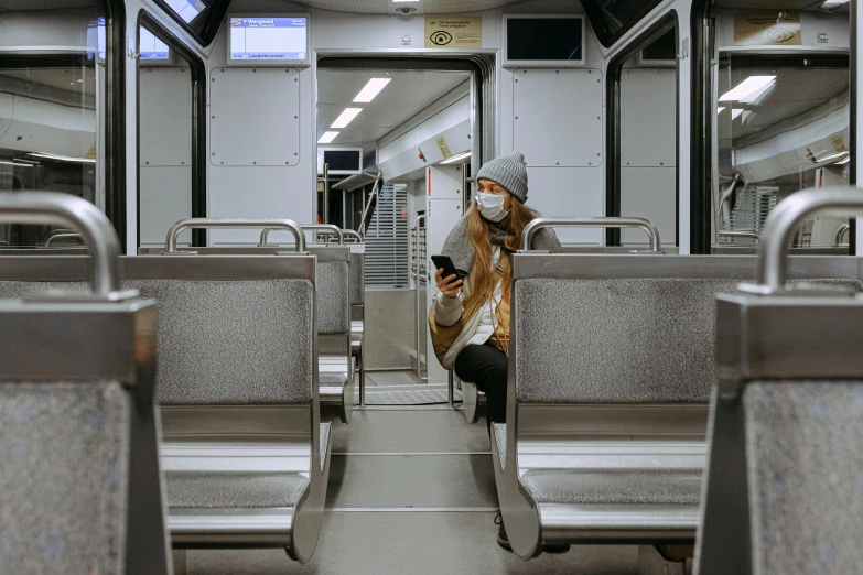 a man sitting on a train looking at his phone, by Adam Marczyński, pexels contest winner, hyperrealism, people are wearing masks, panoramic view of girl, public bus, sitting in an empty white room