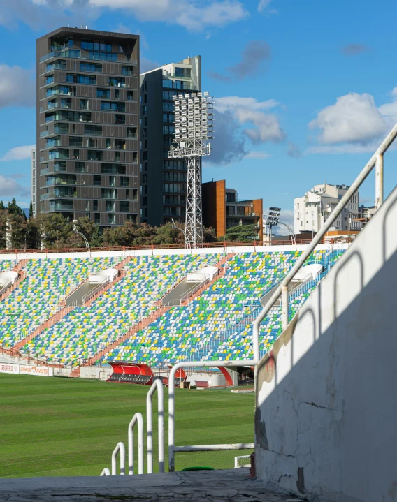 a man riding a skateboard on top of a green field, inspired by Modest Urgell, pexels contest winner, graffiti, stadium full of people, colorful tiled architecture, el anatsui, gif