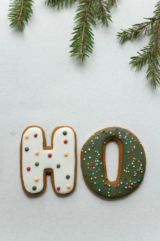 a couple of doughnuts sitting on top of a table, bubble letters, christmas, h0, product shot