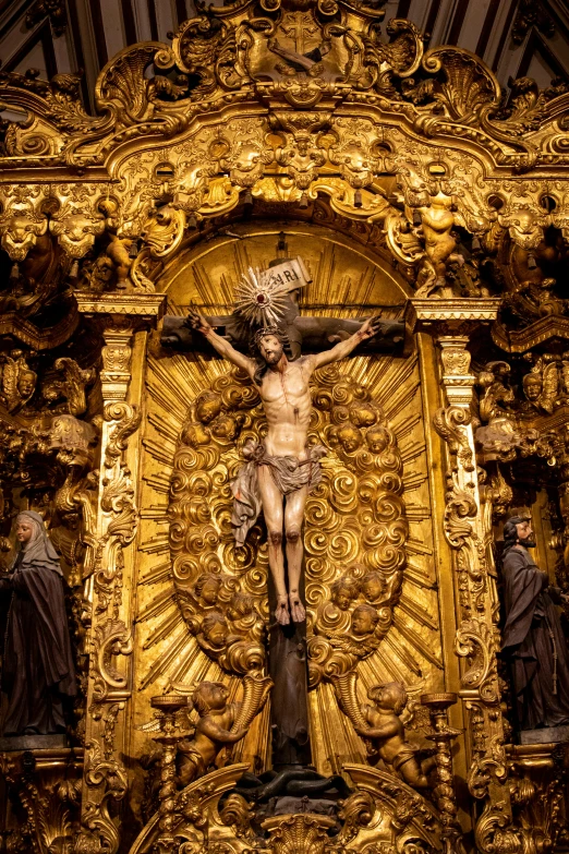 a statue of jesus on the cross in a church, by Matthias Stom, pexels contest winner, baroque, seville, ornate with gold trimmings, panel, kris kuksi