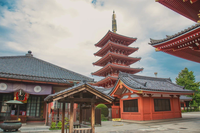 a building with a pagoda in the background, inspired by Itō Jakuchū, pexels contest winner, brightly colored buildings, red building, tall stone spires, peaked wooden roofs