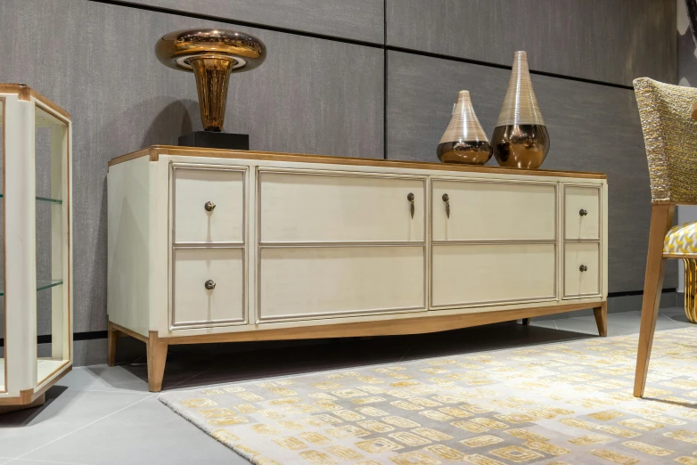 a white cabinet sitting next to a chair in a room, modernism, beige and gold tones, pininfarina, vintage - w 1 0 2 4, server in the middle