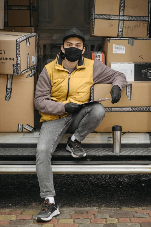 a man sitting on the back of a van filled with boxes, a portrait, by Jason Felix, pexels contest winner, renaissance, wearing facemask, yellow and charcoal leather, yihao ren, holding a clipboard