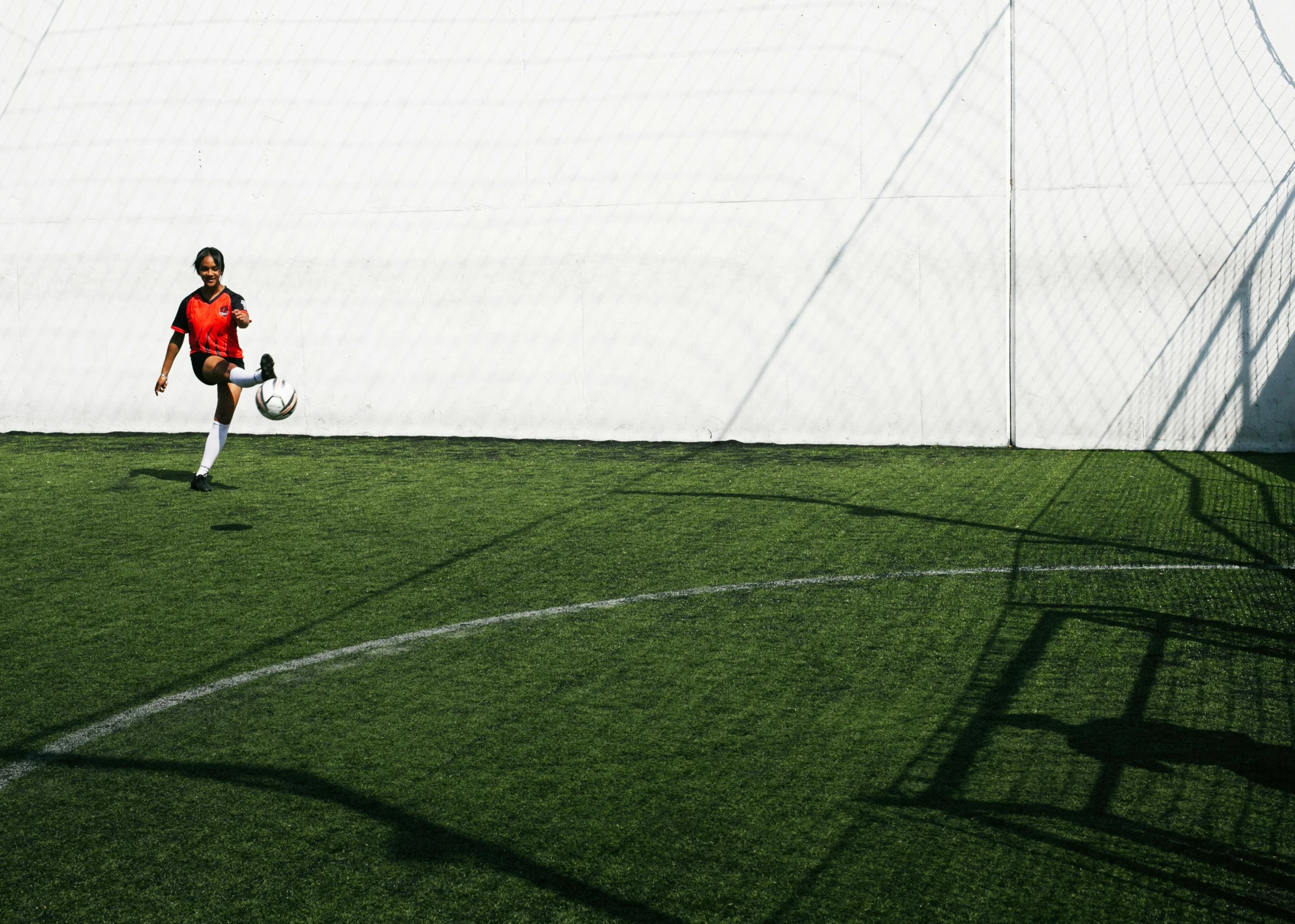 a man standing on top of a soccer field holding a soccer ball, by Carey Morris, pexels contest winner, realism, minimalist rule of thirds, a girl playing tennis, panoramic shot, hunting