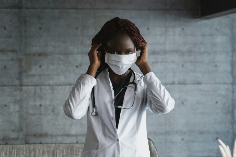 a woman in a white lab coat with a stethoscope on her head, pexels contest winner, afrofuturism, white man with black fabric mask, brown, healthcare, greys