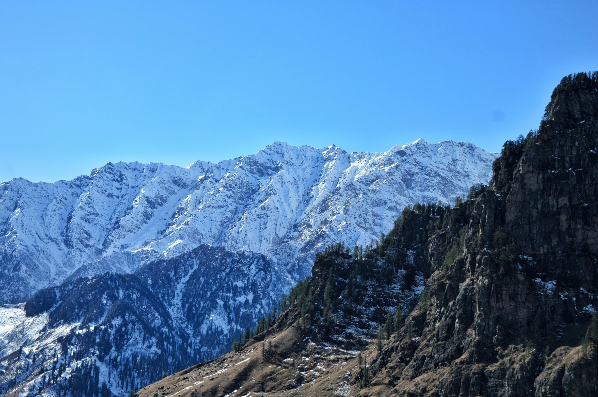 a group of people standing on top of a snow covered mountain, pexels contest winner, hurufiyya, clear blue skies, india, gorge in the mountain, thumbnail