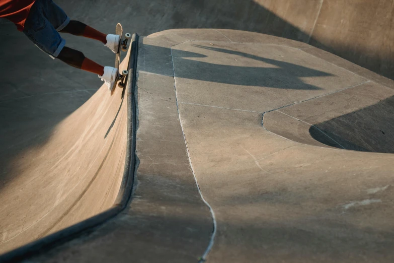 a man riding a skateboard up the side of a ramp, by Jay Hambidge, pexels contest winner, concrete art, very detailed curve, brown, 15081959 21121991 01012000 4k, aerial iridecent veins