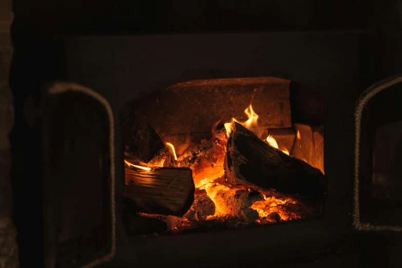 a close up of a fire in a fireplace, pexels contest winner, light inside the hut, warm coloured, woodfired, instagram post