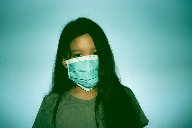 a close up of a person wearing a face mask, an album cover, by Ren Hang, pexels contest winner, hurufiyya, little kid, healthcare worker, teen girl, plague and fever. full body