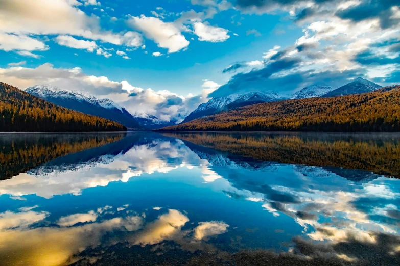 a large body of water with mountains in the background, by Julia Pishtar, pexels contest winner, mirror lake, big sky, national - geographic, fall season
