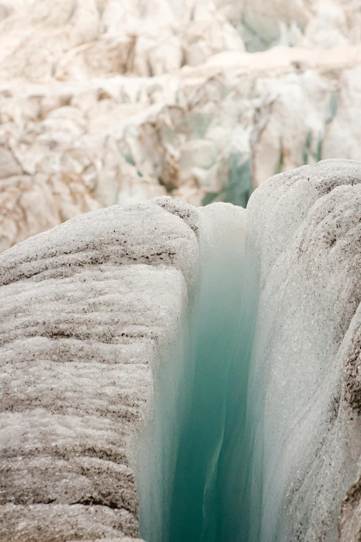 a group of people standing on top of a glacier, a macro photograph, by Alison Geissler, romanticism, waterfall walls, mint, 2022 photograph, polar