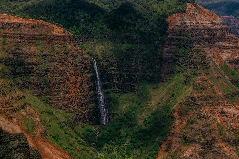 a waterfall in the middle of a lush green valley, by Daniel Lieske, pexels contest winner, hurufiyya, landscape with red mountains, ( ( ( ( kauai ) ) ) ), panoramic shot, fan favorite