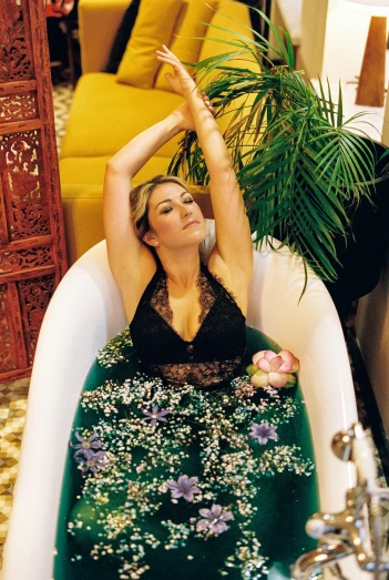 a woman taking a bath in a bathtub, an album cover, inspired by Elsa Bleda, unsplash, renaissance, sunny leone, lotus pose, ana de armas portrait, sitting on a couch