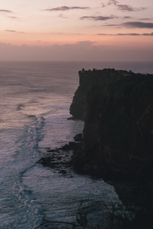 a large body of water next to a cliff, pexels contest winner, bali, in a sunset haze, rough seas, high view