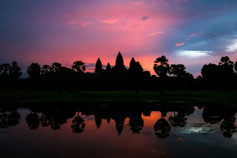 a sunset over a body of water with trees in the background, inspired by Steve McCurry, pexels contest winner, hurufiyya, angkor wat, avatar image, pink marble building, 2 0 2 2 photo