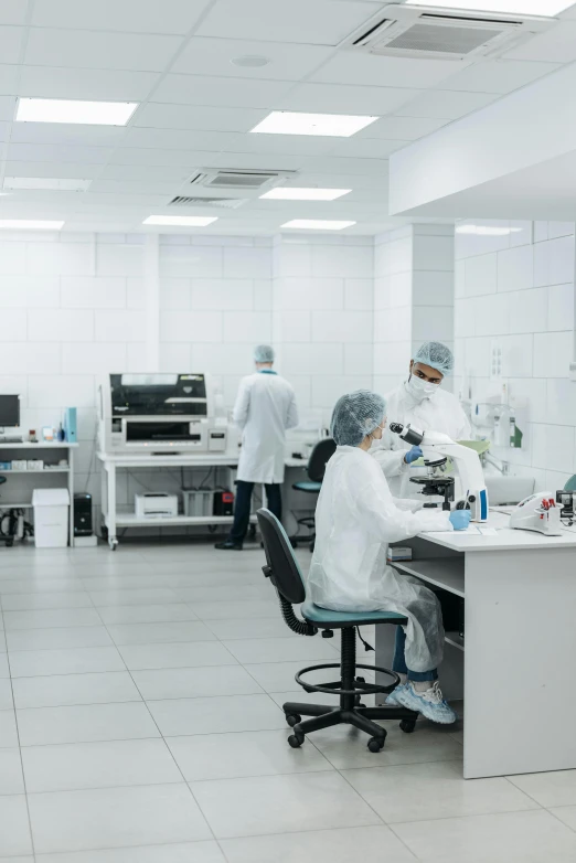 a group of people working in a lab, shutterstock, sterile minimalistic room, low quality photo, thumbnail