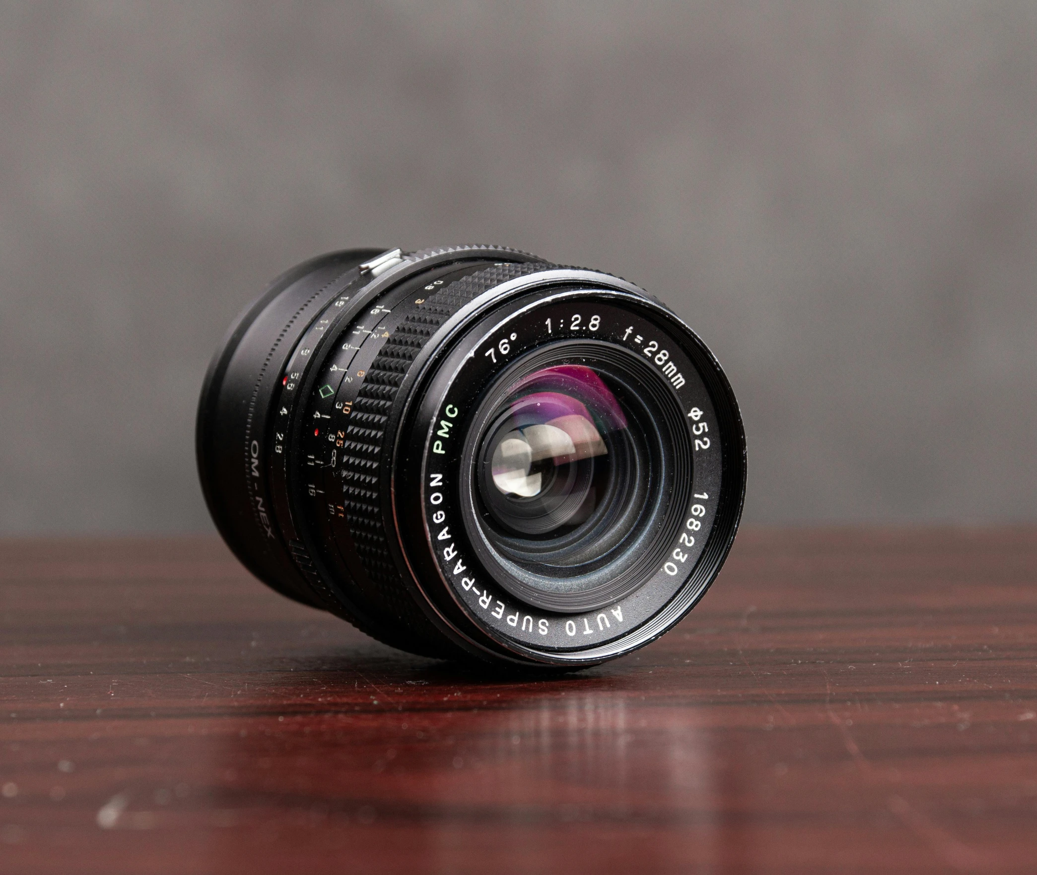 a camera lens sitting on top of a wooden table, by Jason Felix, unsplash, photorealism, hasselblad medium format, leica summicron-t 23 mm f/2, medium wide front shot, fuji provia