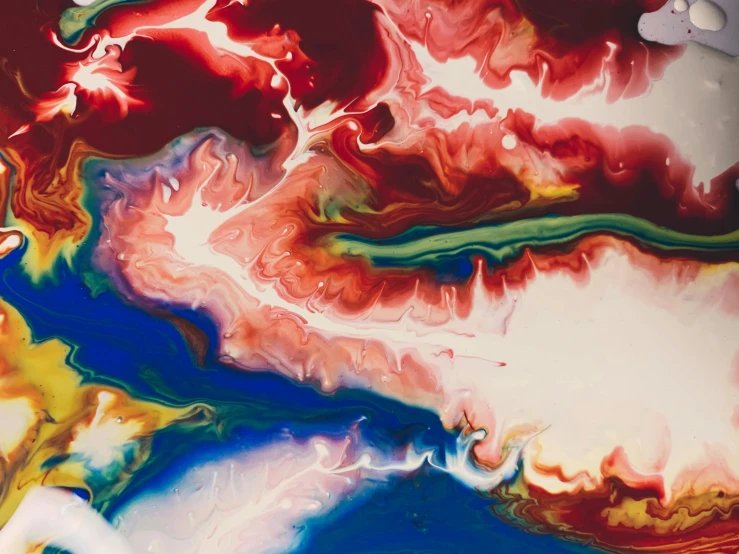 a close up of a painting on a table, inspired by Shōzō Shimamoto, trending on pexels, abstract art, aerial iridecent veins, red fluid, rainbow liquids, lsd waves