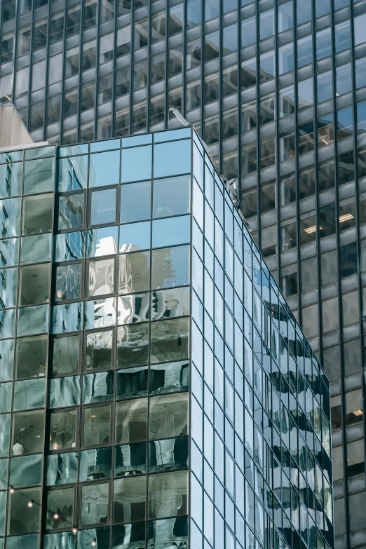 a clock that is on the side of a building, with shiny glass buildings, window ( city ), stacked buildings, zoomed in