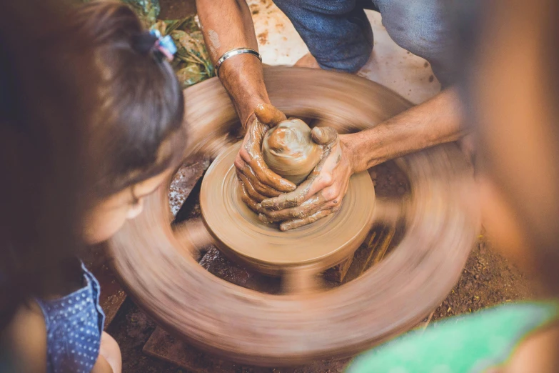 a group of people working on a pottery wheel, by Elizabeth Durack, pexels contest winner, little kid, instagram story, natural beauty, promo image