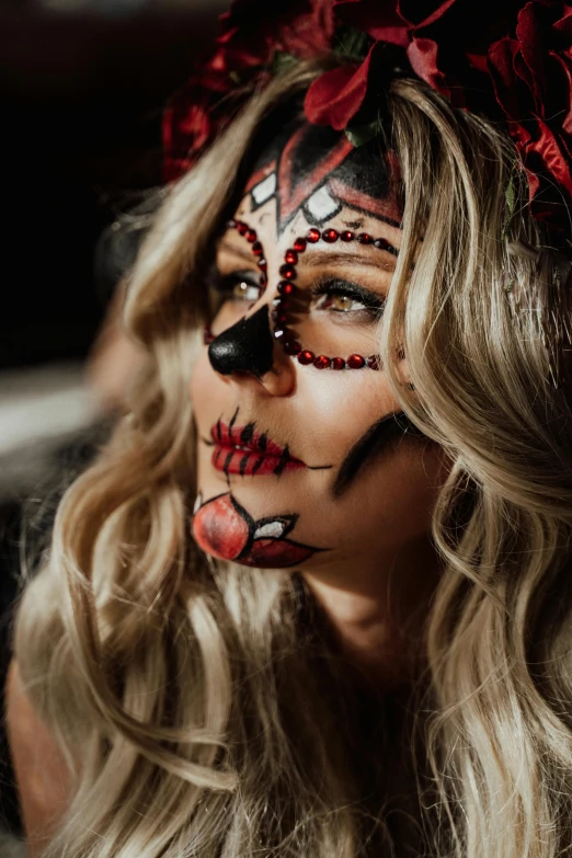 a woman wearing day of the dead makeup, by Julia Pishtar, close up of a blonde woman, cheeky devil, black and red colour palette, profile image