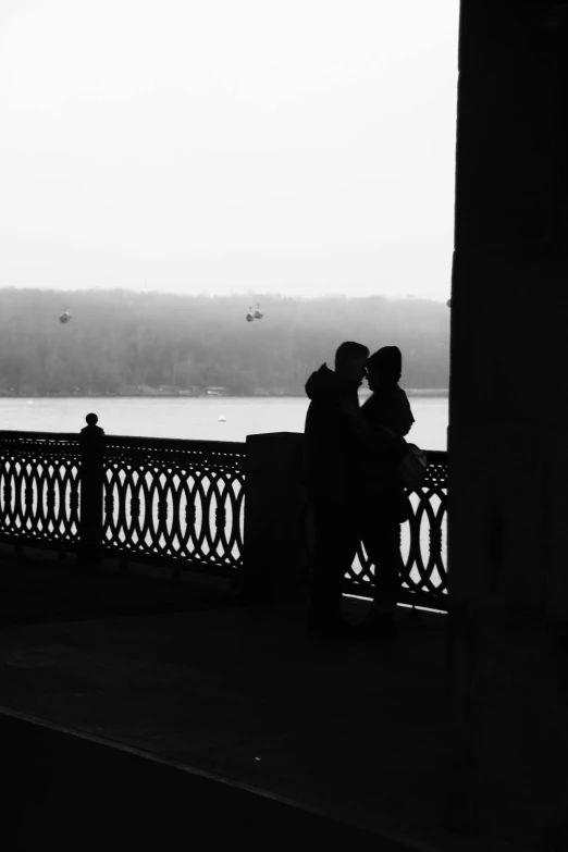 a couple standing next to each other on a bridge, inspired by Louis Stettner, romanticism, silhouette!!!, at the terrace, taken in the late 2010s, french kiss