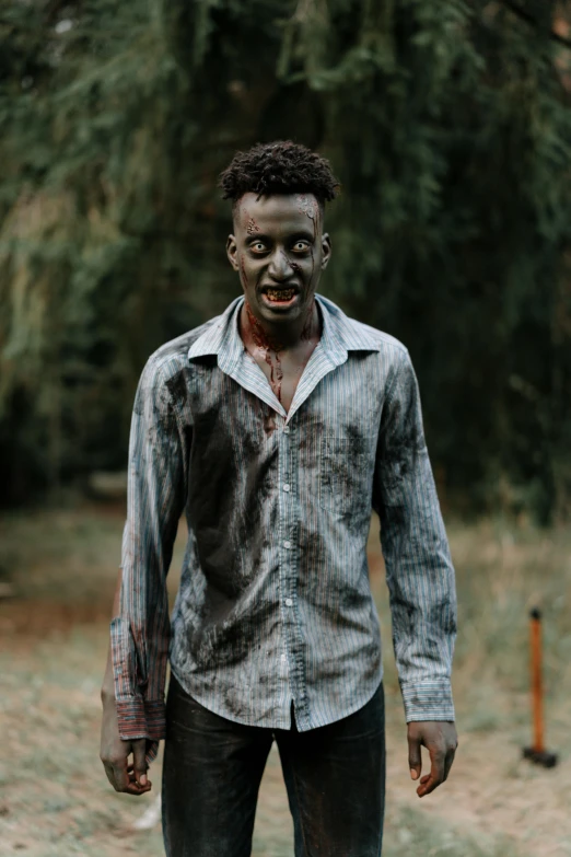 a man dressed as a zombie standing in a field, pexels contest winner, brown skinned, ( ( theatrical ) ), college, grey skinned