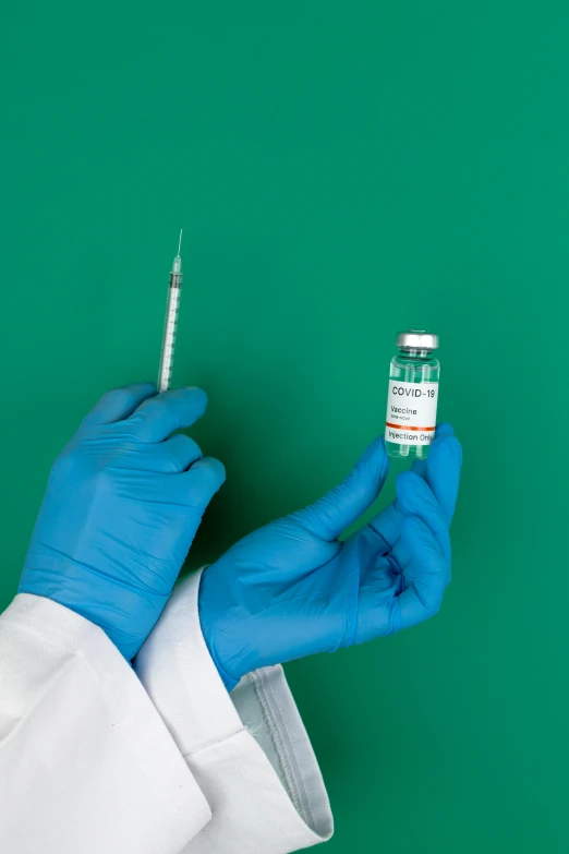 a person in blue gloves holding a syet, shutterstock, holding a syringe, instagram picture, 2654465279, a green