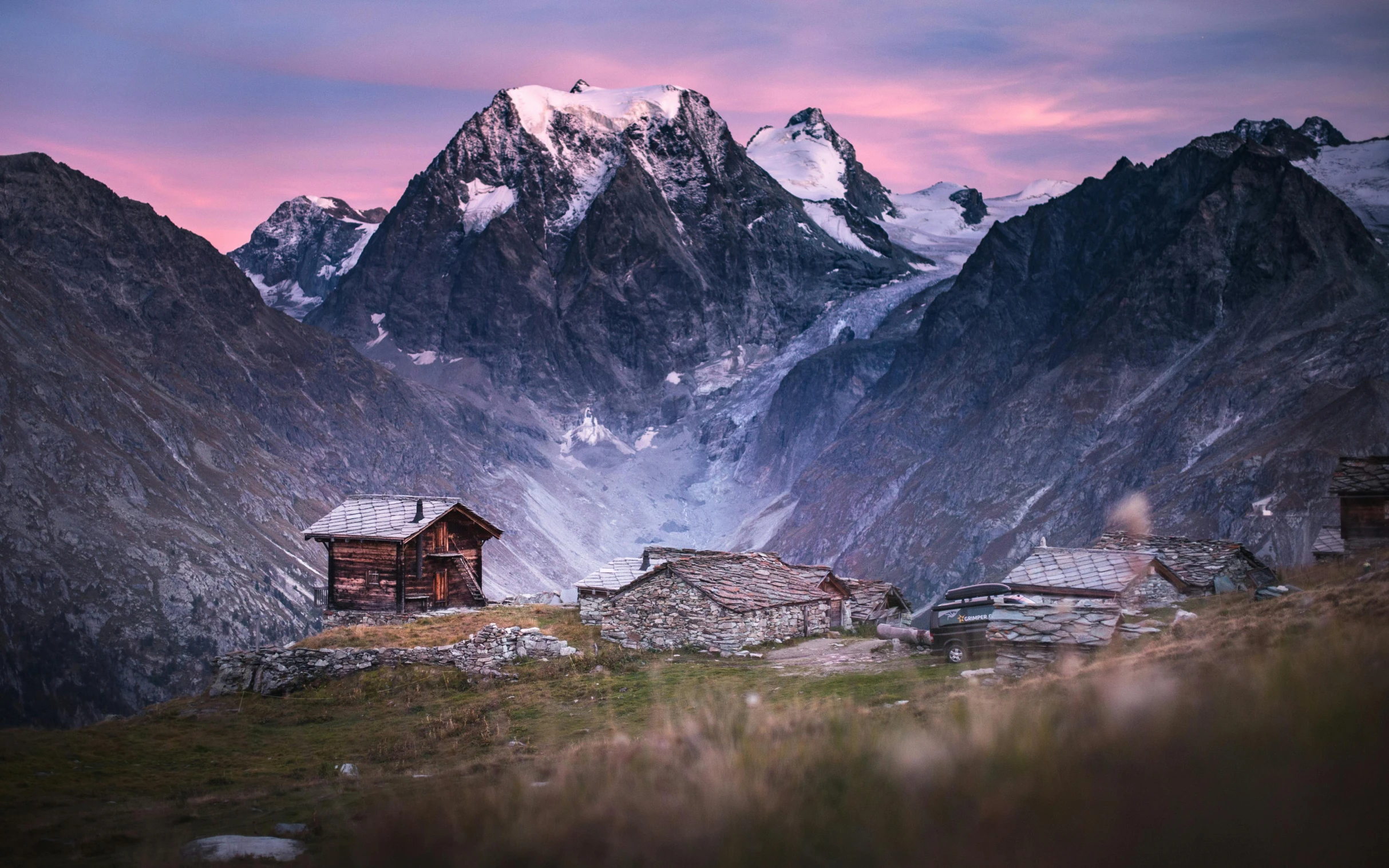 a couple of cabins sitting on top of a mountain, a matte painting, by Peter Churcher, unsplash contest winner, renaissance, last light on mountain top, lpoty, hut, conde nast traveler photo