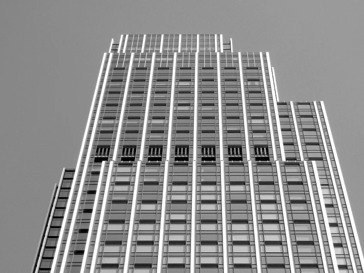 a black and white photo of a tall building, inspired by David Chipperfield, unsplash, of mad men on madison avenue, an extremely detailed building, square lines, high details photo