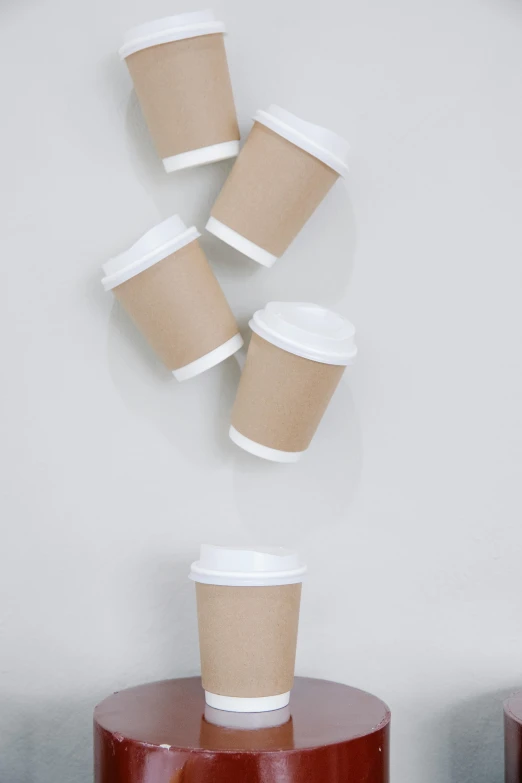 a group of coffee cups sitting on top of a table, detailed product image, shot from below, thumbnail, brown paper
